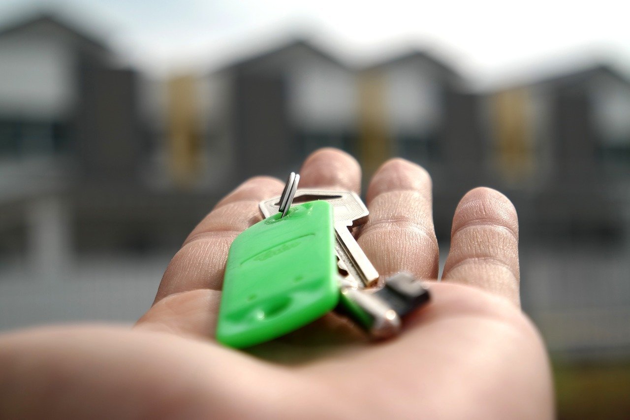 A buyer holding the key to their new home